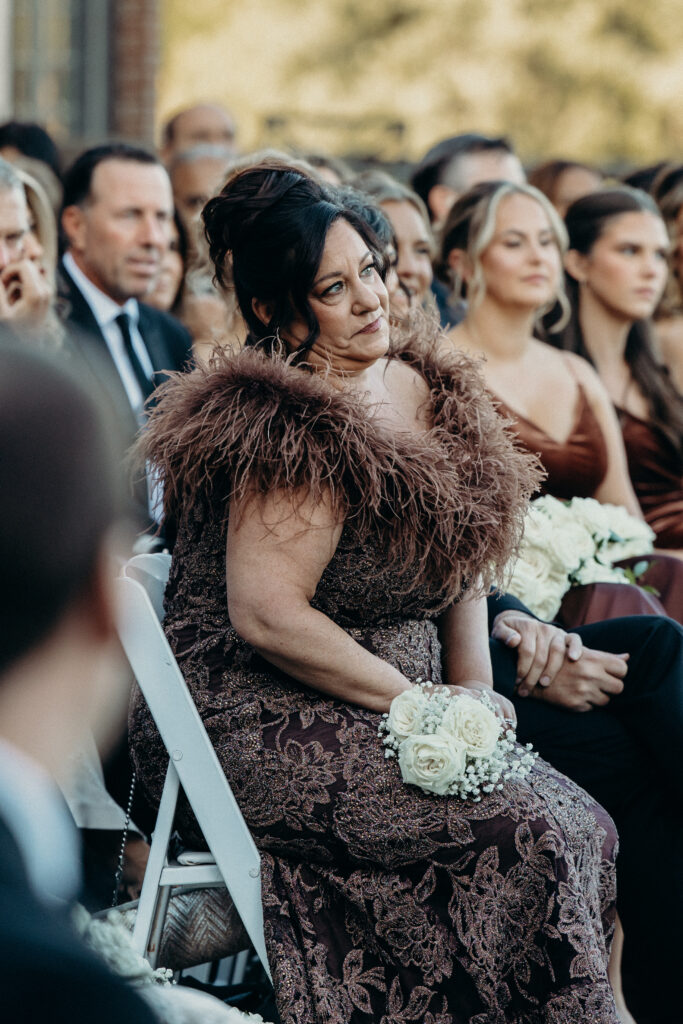 Family and guests during wedding ceremony photographed by brooklyn wedding photographer at diamond mills