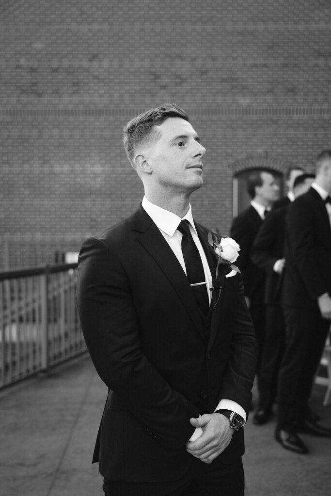 Groom waits for the bride to walk down the aisle at new york wedding venue diamond mills