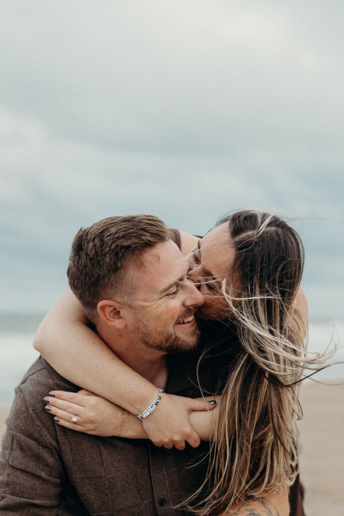 Engaged couple photographed at jersey shore by a brooklyn wedding photographer