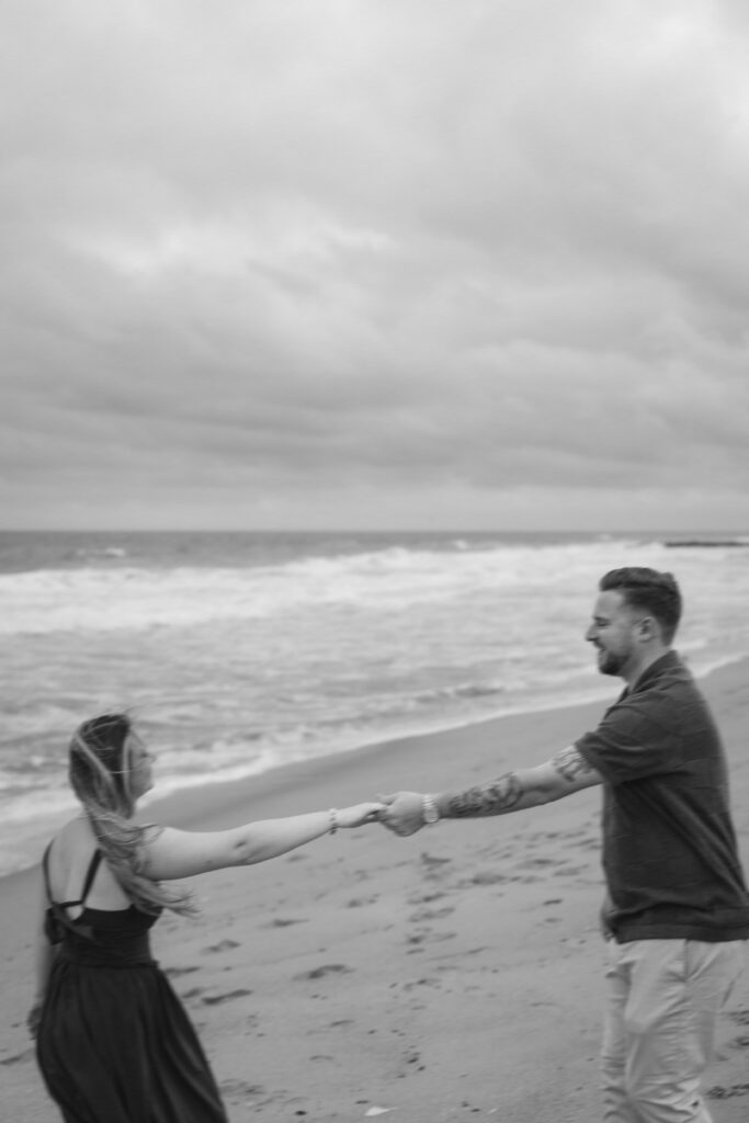 Engaged couple photographed at jersey shore by a brooklyn wedding photographer