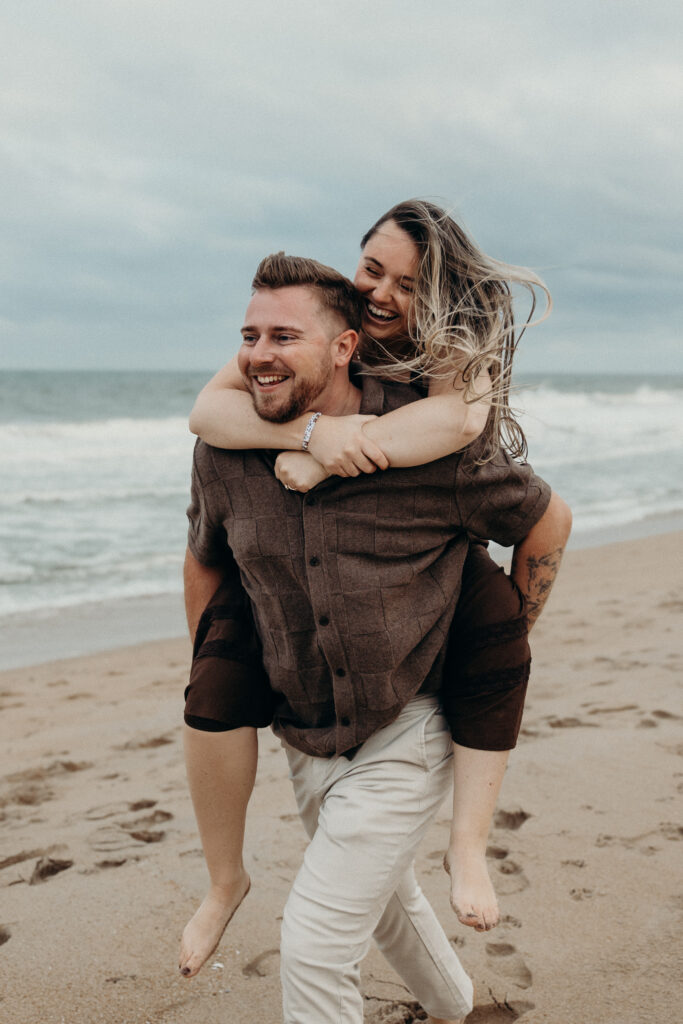 Engaged couple photographed at jersey shore by a brooklyn wedding photographer