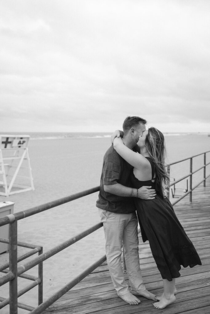 Engaged couple photographed at jersey shore by a brooklyn wedding photographer