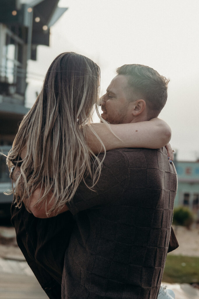 Engaged couple photographed at jersey shore by a brooklyn wedding photographer