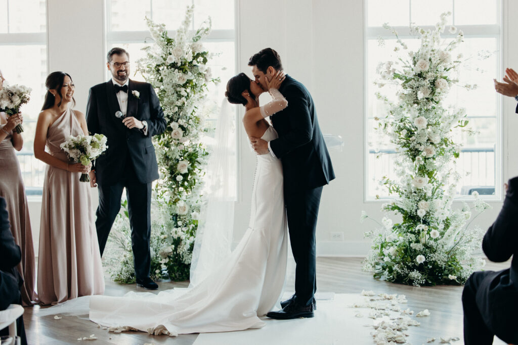 Bride and groom first kiss at jersey city wedding venue maritime parc