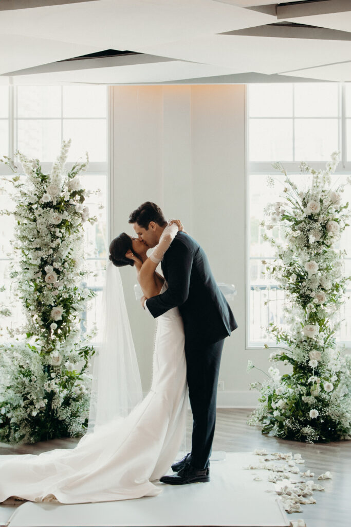 Bride and groom first kiss at jersey city wedding venue maritime parc