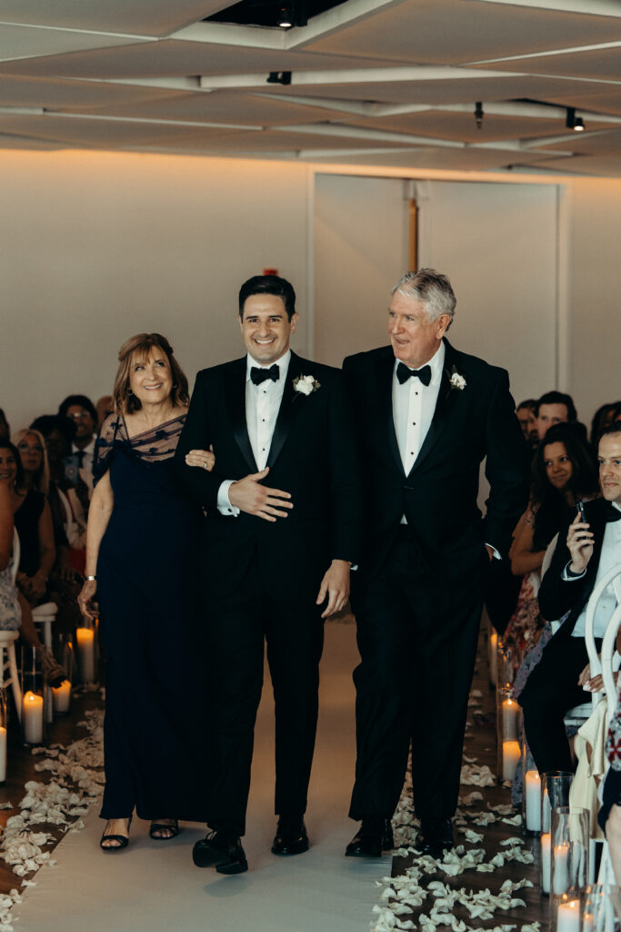 Groom walks down the aisle with parents at new jersey wedding venue maritime parc