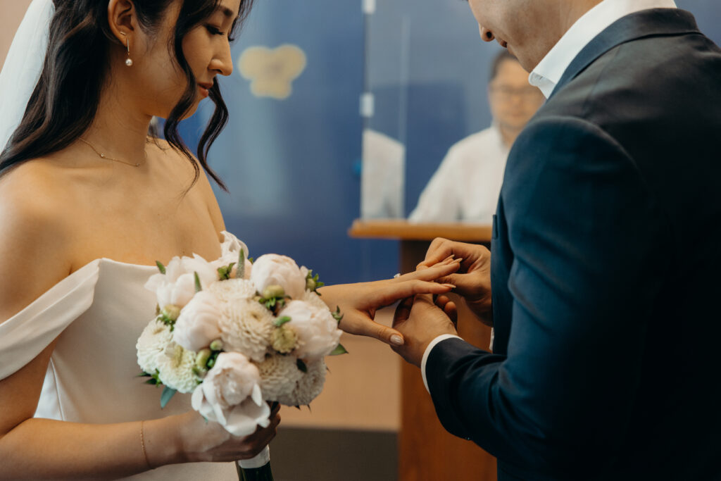 Bride and groom exchange rings at new york city elopement venue nyc city hall