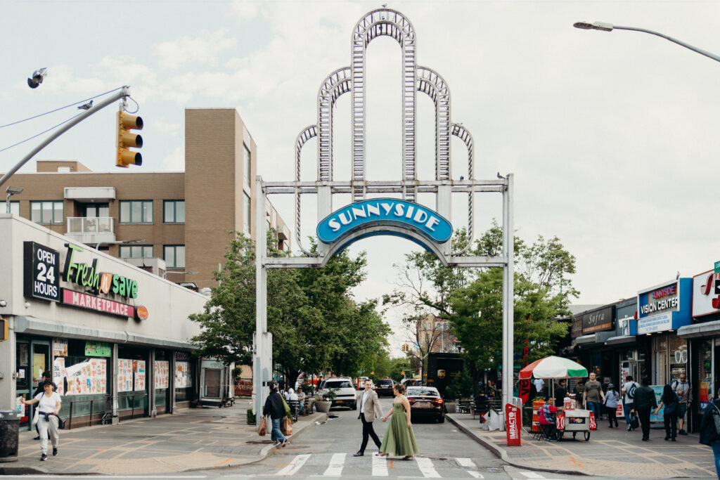 Couple crosses the street during an engagement session in Sunnyside