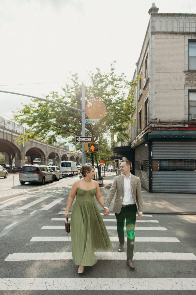 Couple crosses the street during an engagement session in Sunnyside