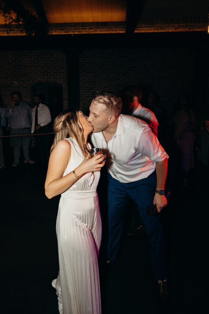 Bride and groom kiss during evening reception at Perona Farms NJ