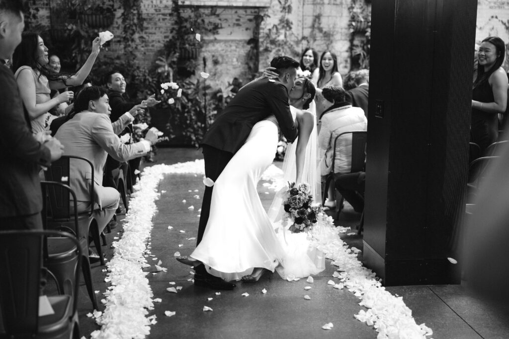 Bride and groom kiss down the aisle at Brooklyn Winery