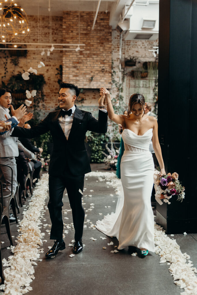 Bride and groom walk down the aisle at Brooklyn Winery