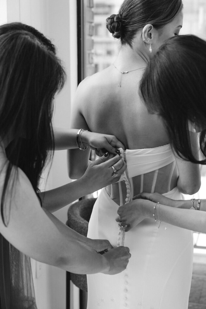 Bride putting her dress on at Brooklyn Winery