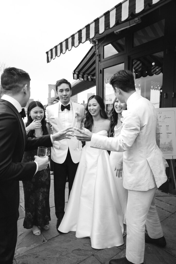 Bride and groom interact with guests during cocktail hour at The River Café NYC