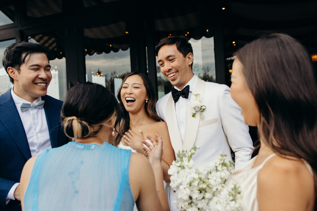 Bride and groom interact with guests during cocktail hour at The River Café NYC