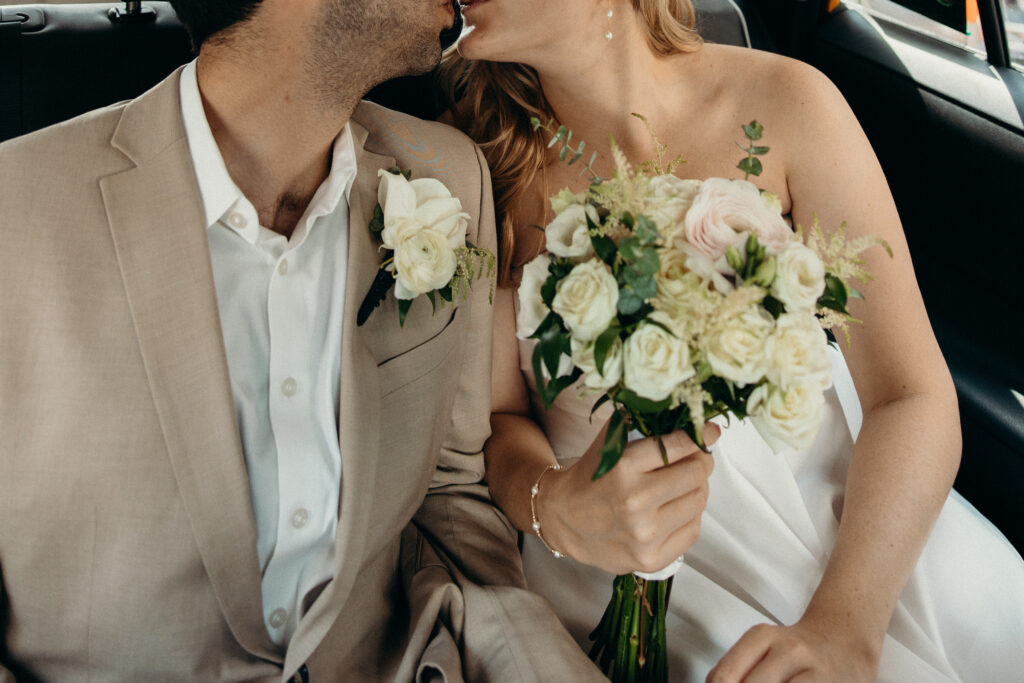 Couple traveling by taxi to NYC City Hall for their elopement