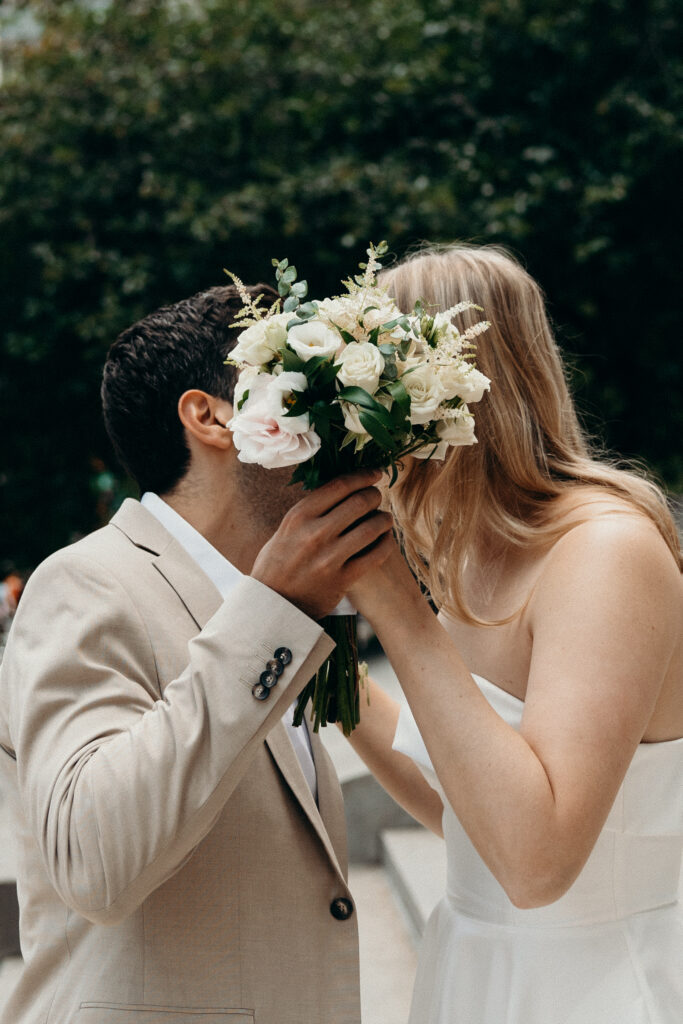 NYC elopement photographer photographing the couple at NYC City Hall