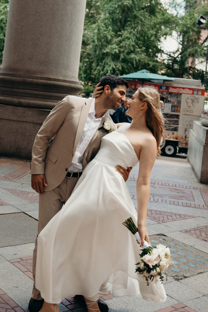 NYC elopement photographer photographing the couple at NYC City Hall