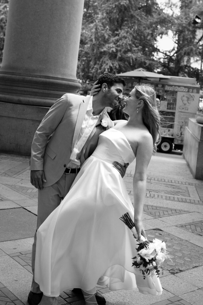 NYC elopement photographer photographing the couple at NYC City Hall