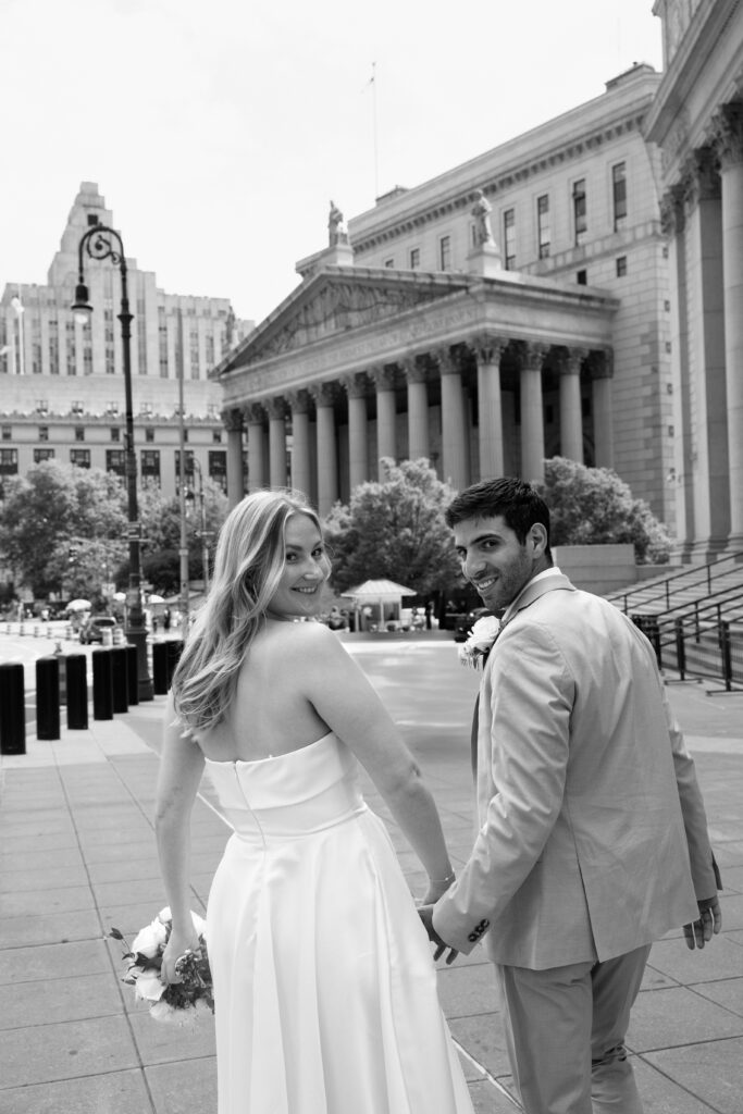 NYC elopement photographer photographing the couple at NYC City Hall