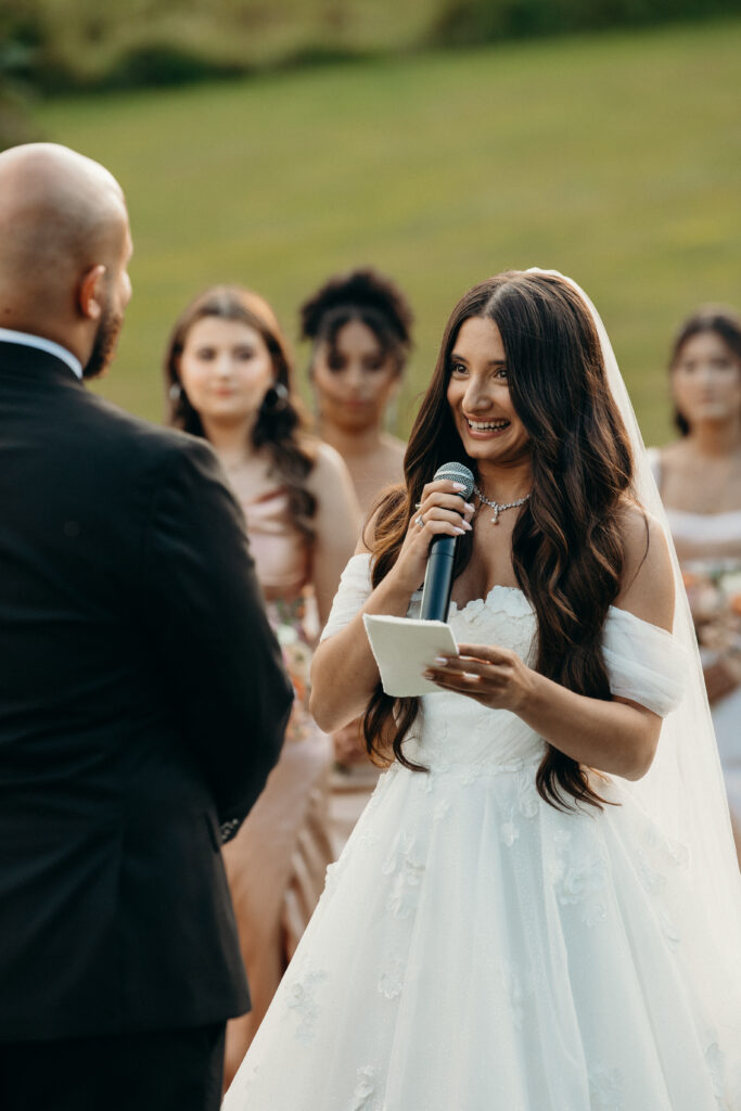 Bride shares vows during wedding ceremony at Stonewall Estate