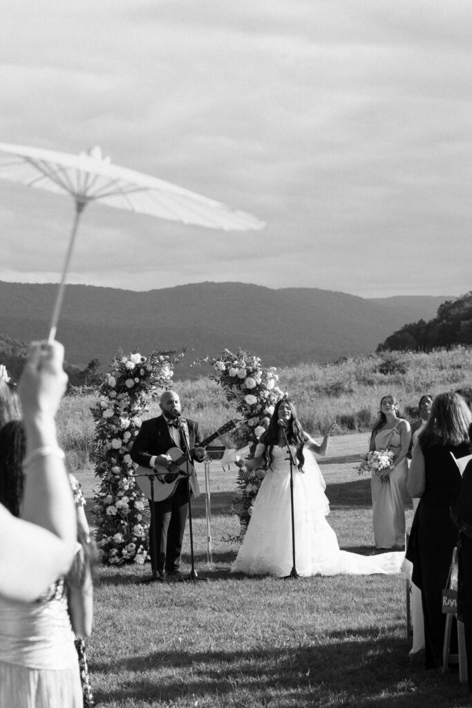Bride and groom performing during wedding ceremony at Stonewall Estate