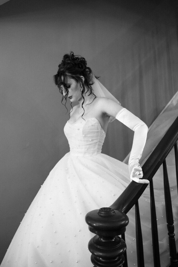 Bride walks down the stairs at Mountainville Manor