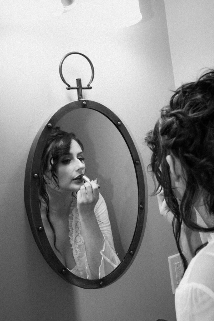 Bride putting on lipstick at Mountainville Manor