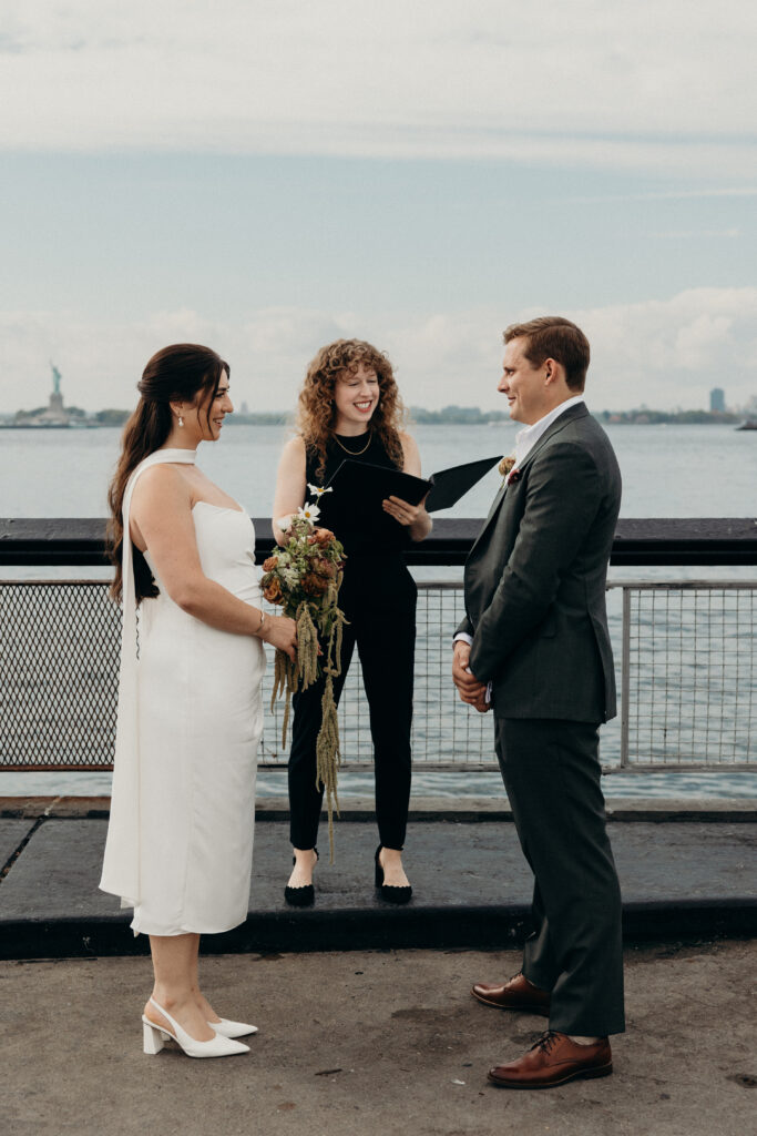 NYC couple faces each other during their Red Hook elopement ceremony in Brooklyn
