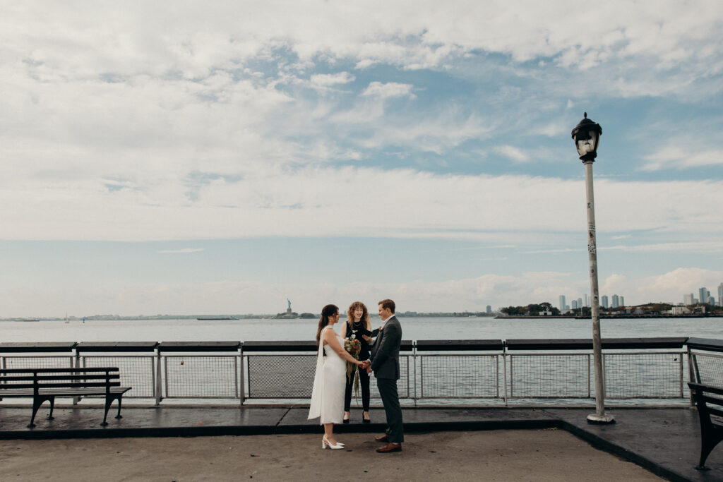 NYC couple holds hands during their Red Hook elopement ceremony in Brooklyn