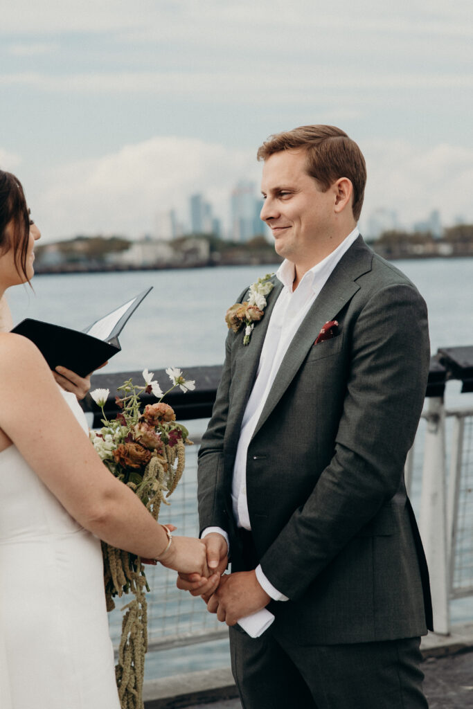 NYC couple holds hands during their Red Hook elopement ceremony in Brooklyn