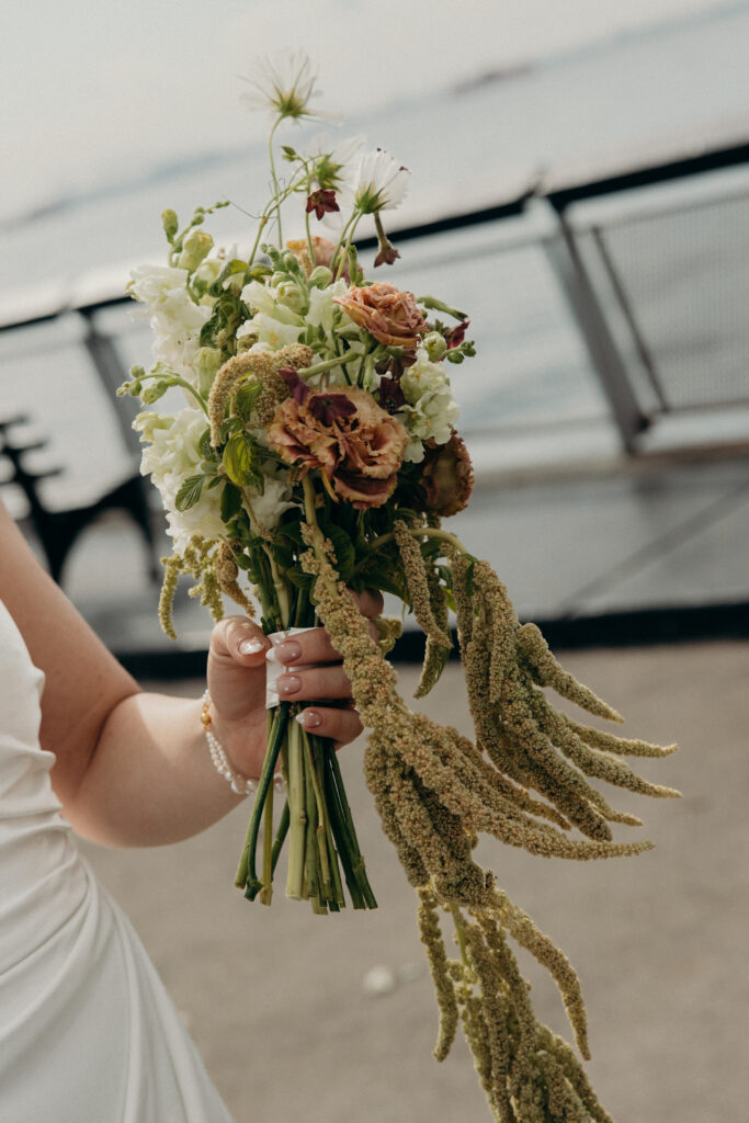 NYC bride holds her elopement bouquet during her Red Hook elopement ceremony in Brooklyn
