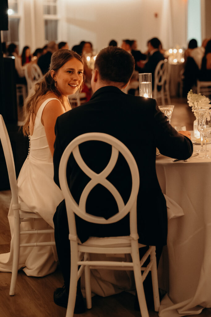 Couple sit during the evening wedding reception at Maritime Parc