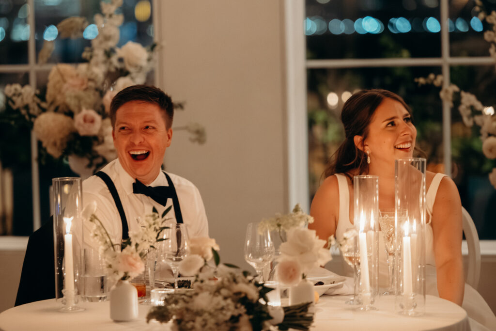 Couple reacts to a speech during their evening wedding reception at Maritime Parc