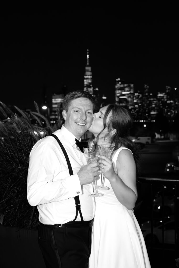 Bride kissing the groom on the cheek during the evening wedding reception at Maritime Parc