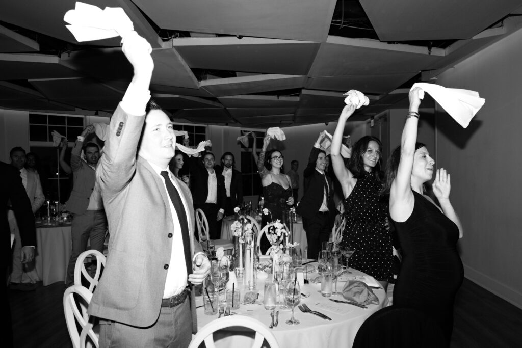 Guests holding and waving their handkerchiefs during the evening wedding reception at Maritime Parc