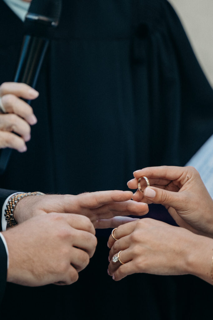 Couple exchanging rings at the Radio Star wedding
