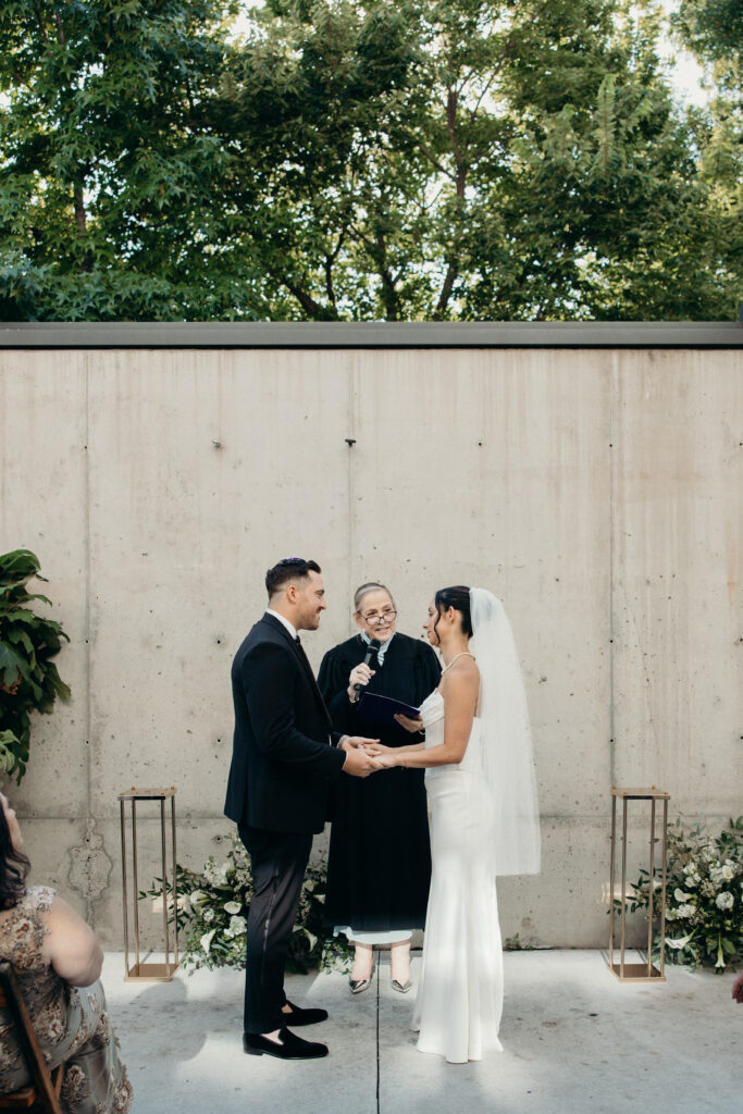 Couple holding hands at the Radio Star wedding
