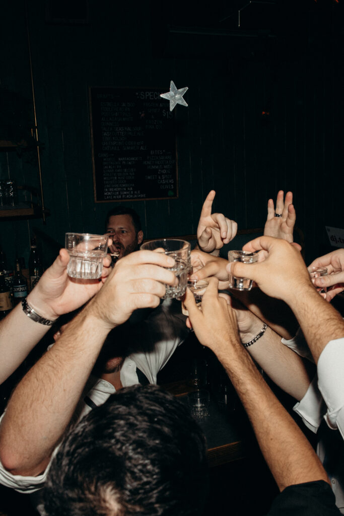 Wedding guests drinking at the Broken Land wedding after-party
