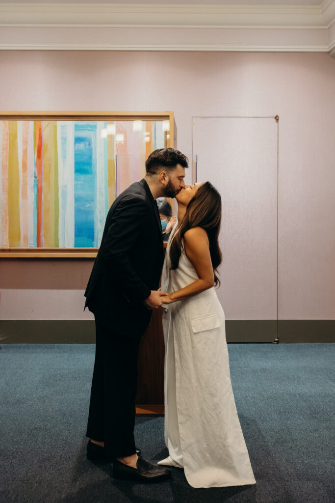 First kiss during elopement ceremony at NYC City Hall