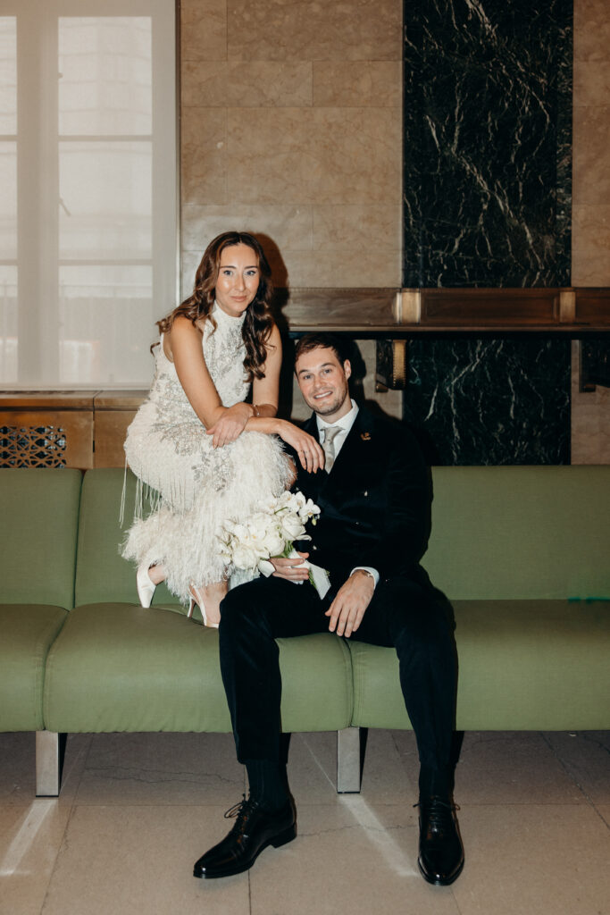 NYC couple sitting on a chair during their NYC City Hall elopement