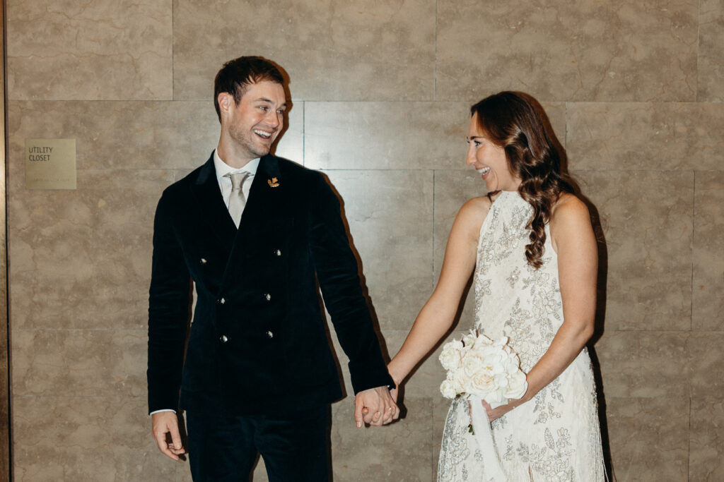 NYC couple holding hands during elopement at NYC City Hall