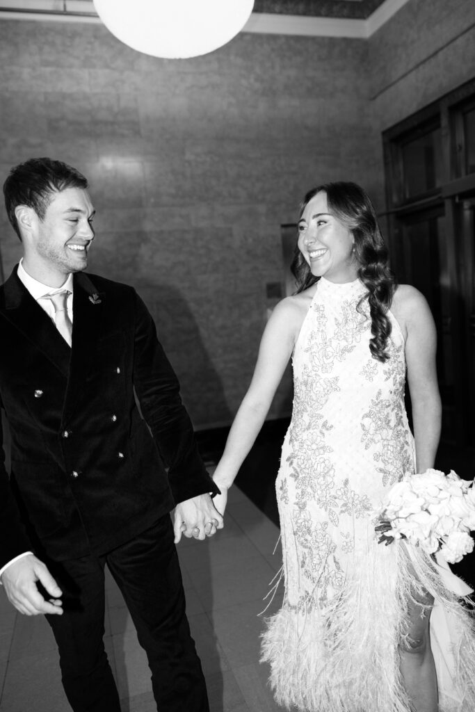 NYC couple holding hands during elopement at NYC City Hall
