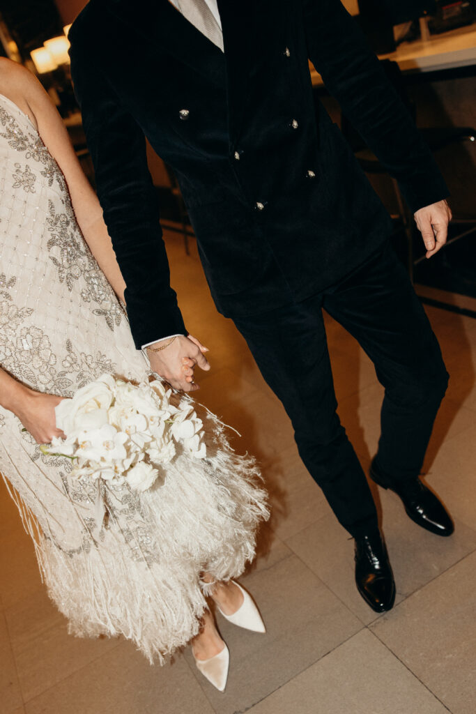 NYC couple holding hands during elopement at NYC City Hall