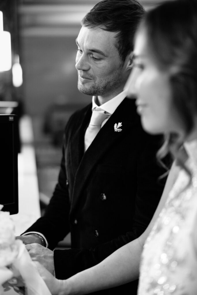 NYC couple signing papers during elopement at NYC City Hall