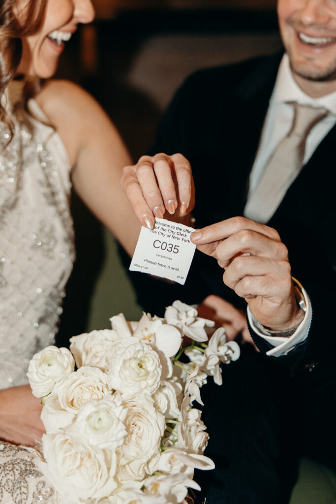 NYC couple holding their City Hall ticket during their NYC City Hall elopement
