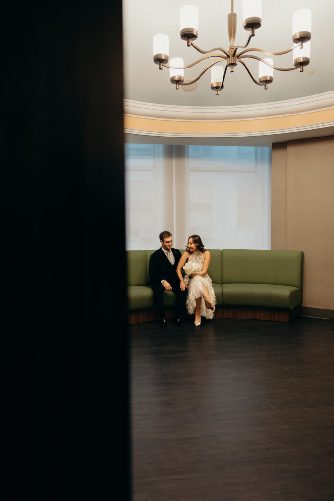 NYC couple sitting on a chair during their NYC City Hall elopement