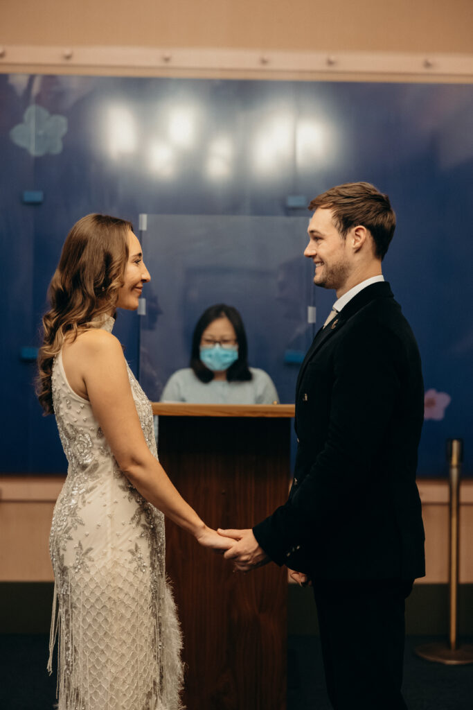 NYC couple exchanging vows during elopement ceremony at NYC City Hall