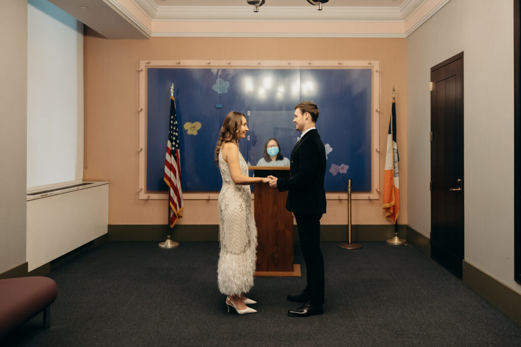 NYC couple exchanging vows during elopement ceremony at NYC City Hall