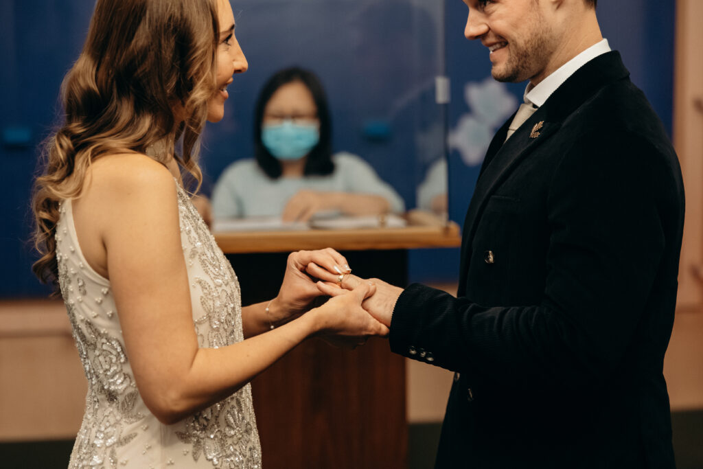 NYC couple exchanging rings during elopement ceremony at NYC City Hall